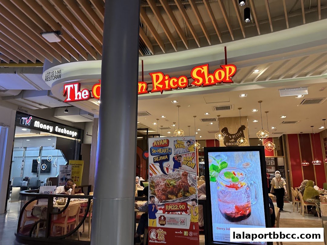 The Chicken Rice Shop storefront with a digital menu displaying a Berry Jelly Fizz drink.