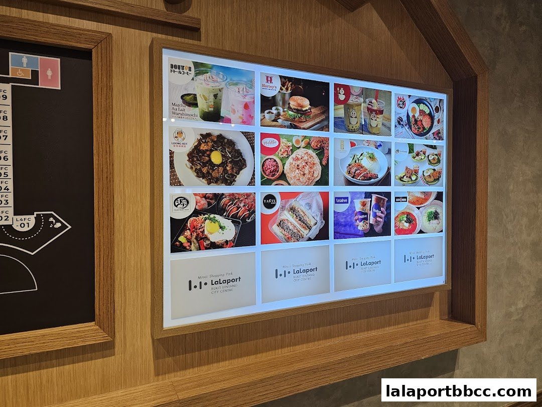 A digital display showcasing various food and drink options available at a food court.