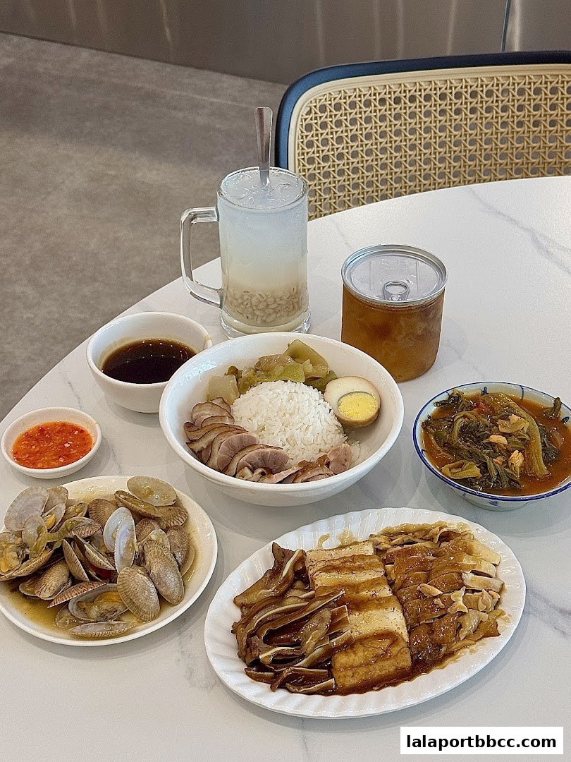 A spread of Teochew porridge with various side dishes and a refreshing drink.