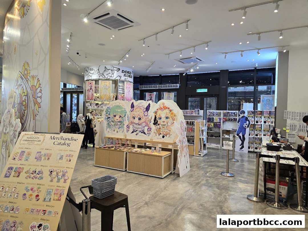 Interior of a brightly lit shop with anime-style merchandise displays and cutouts.