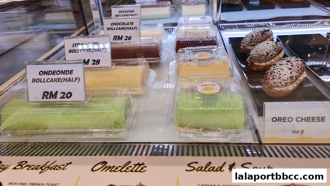 A display case filled with various cakes and pastries, including roll cakes and Oreo cheese.