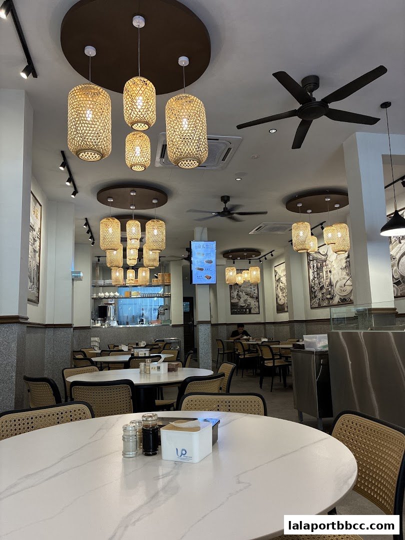 Interior view of a restaurant with tables, chairs, and decorative lighting.