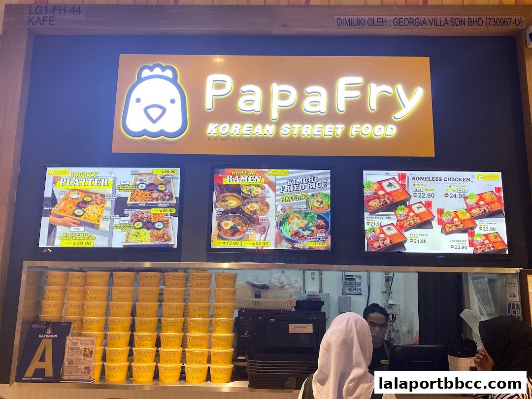 PapaFry Korean Street Food stall with illuminated signage and digital menu displays.