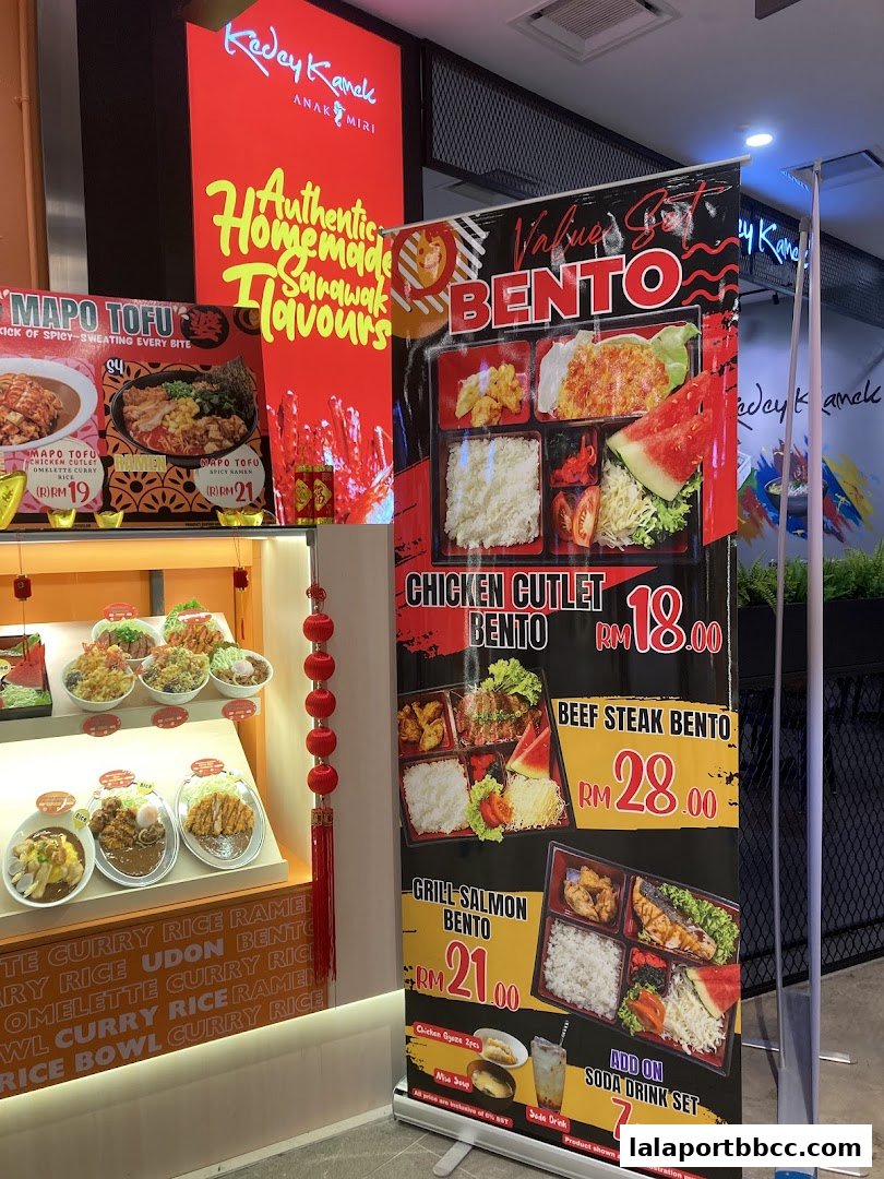 A shop display featuring authentic Sarawak flavors and bento boxes with prices.