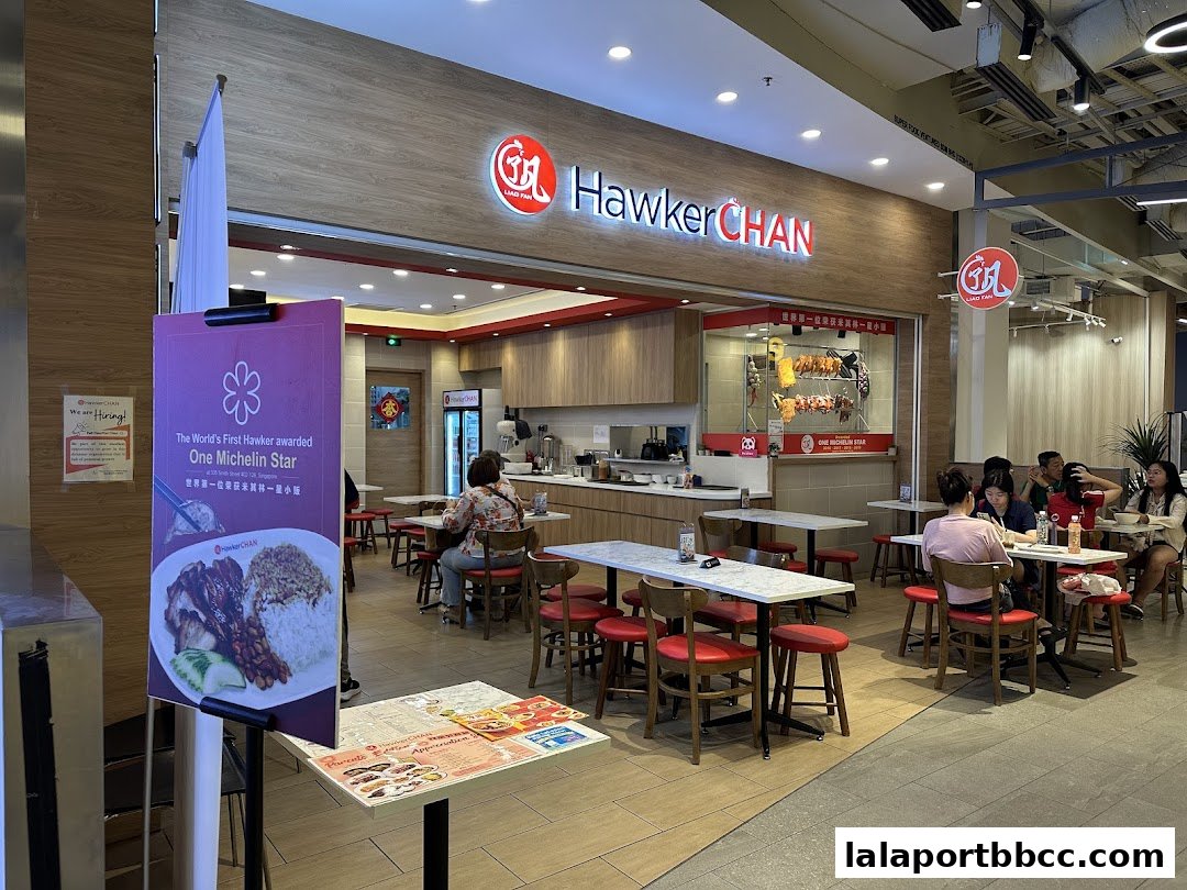 Hawker Chan restaurant interior with customers dining and a sign highlighting its Michelin Star award.