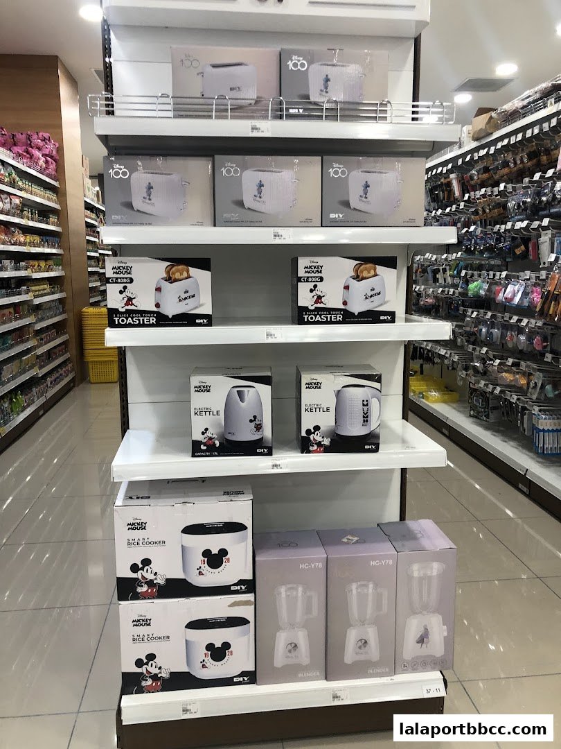 Display shelves filled with Mickey Mouse themed kitchen appliances like toasters, kettles, and rice cookers.