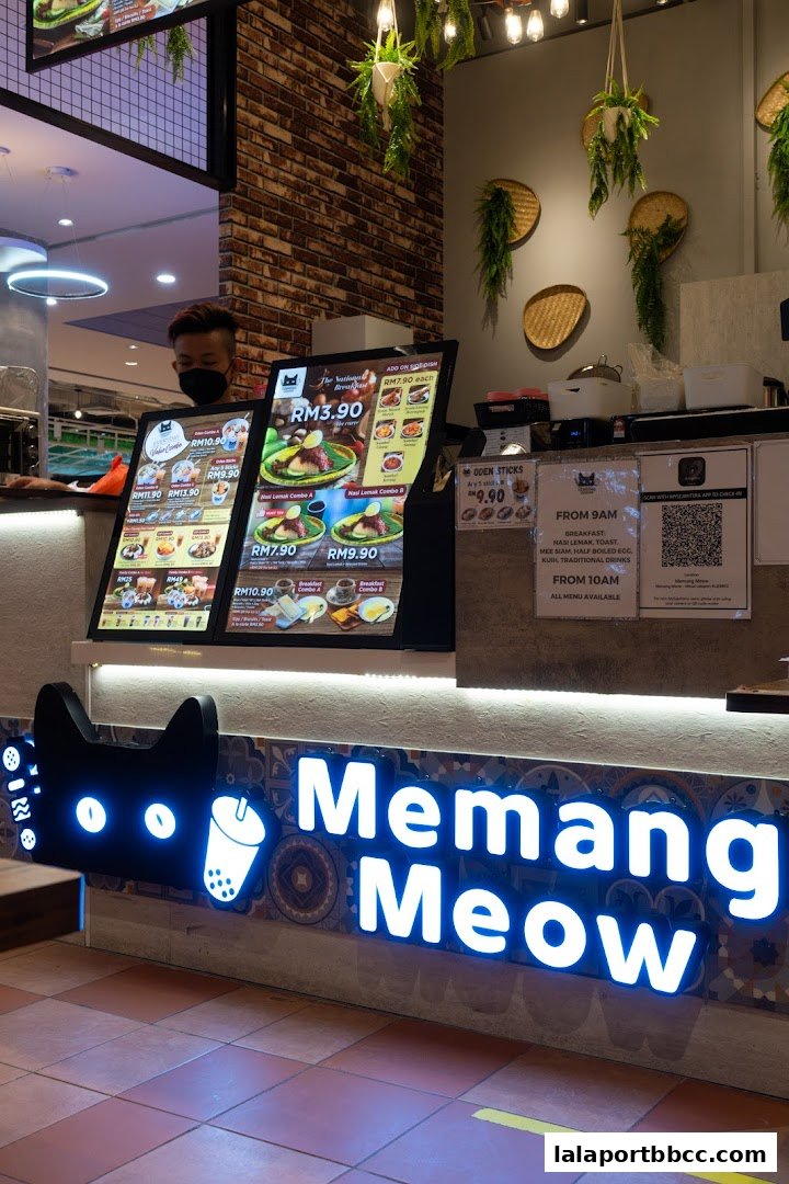 A brightly lit food counter with digital menus displaying various meal options and the shop's name.