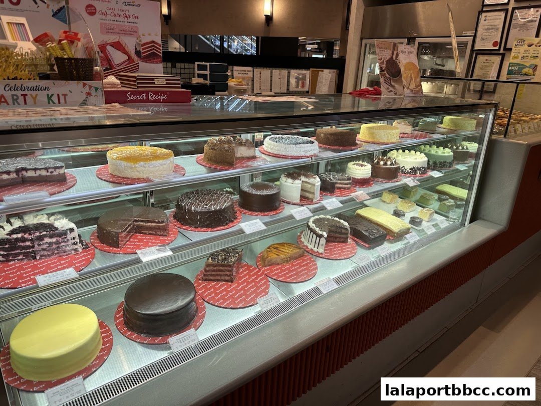 A display case filled with a variety of delicious cakes and desserts at Secret Recipe.