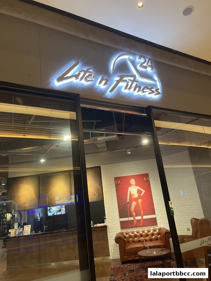 The illuminated 'Life n Fitness' sign above the entrance of a modern gym.