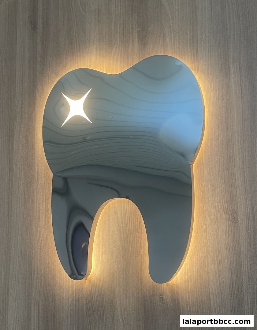 A shiny tooth-shaped sign with a sparkling star, illuminated by warm LED lights.