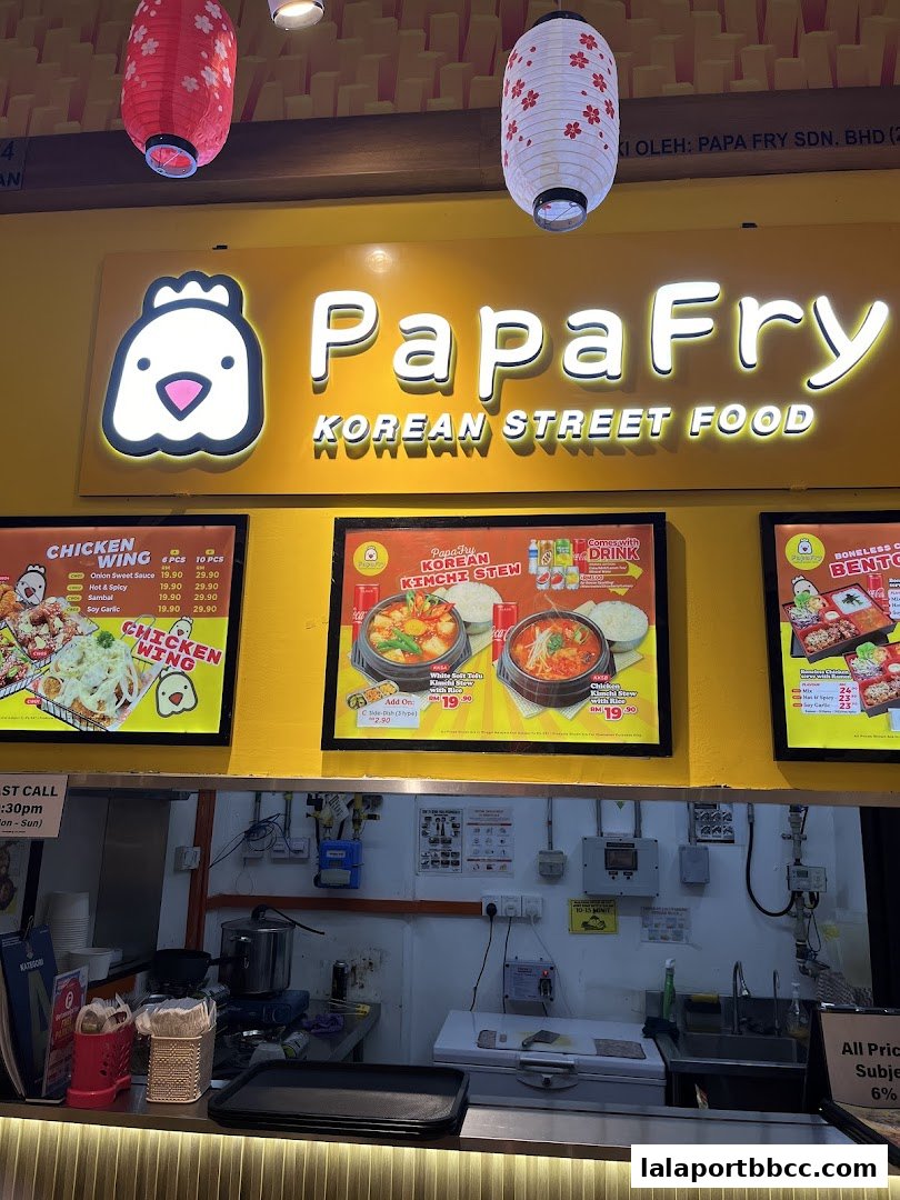 Papa Fry Korean Street Food shop front with menu displays and kitchen area.