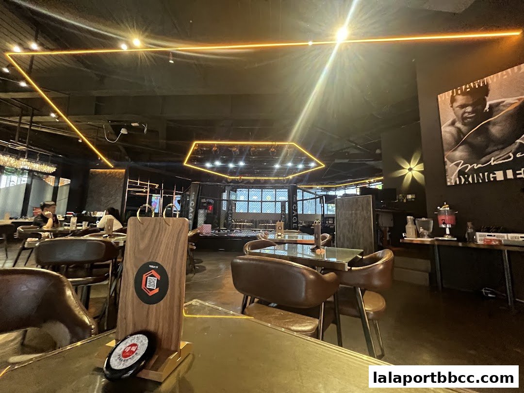 Interior of a modern restaurant with boxing-themed decor and seating.