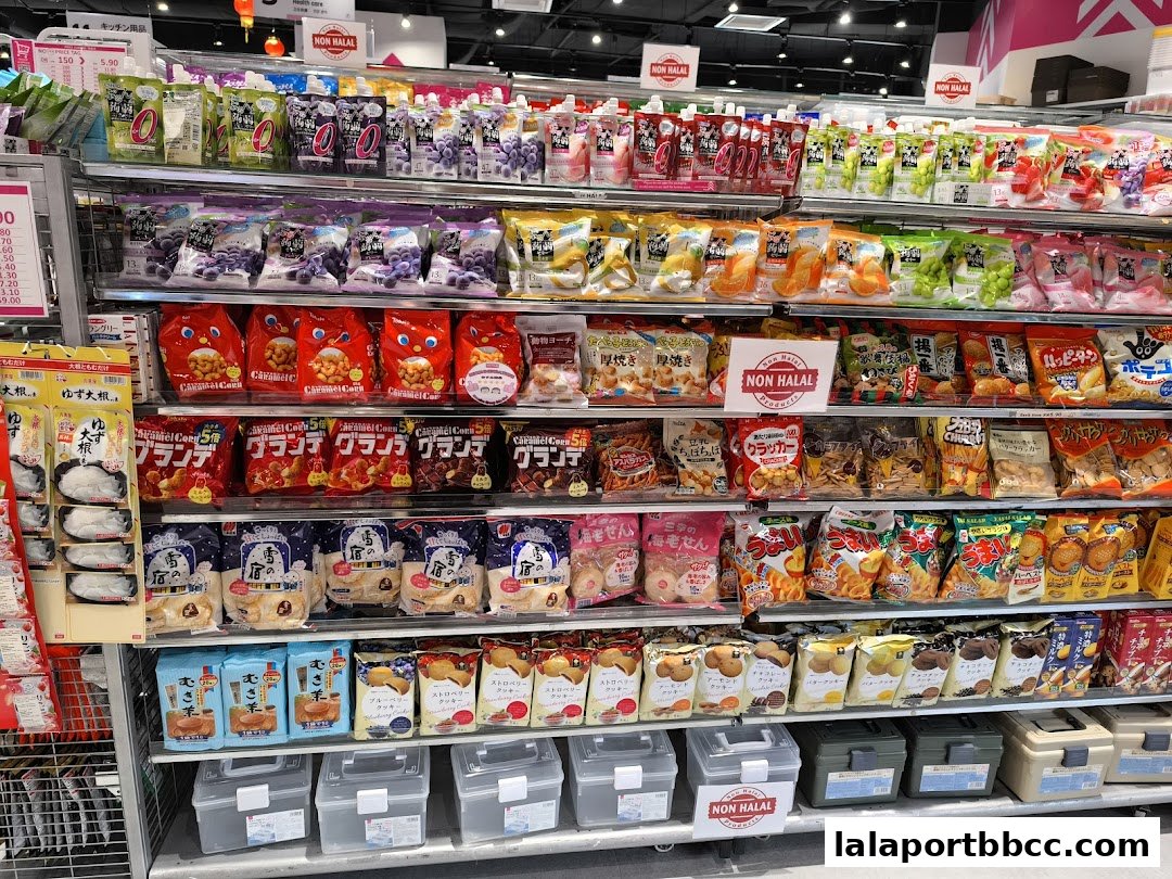 Shelves stocked with a variety of snacks, drinks, and food items, including chips, cookies, and pouches.