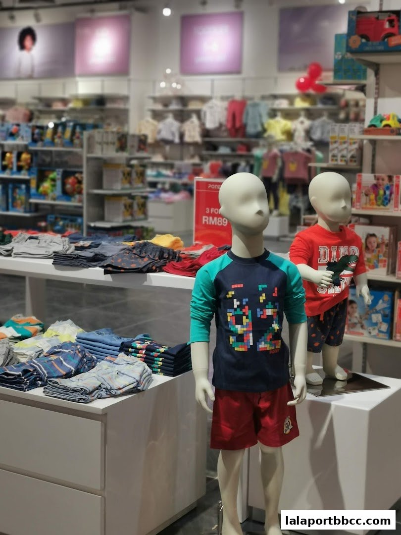 Mannequins display children's clothing in a brightly lit retail store.