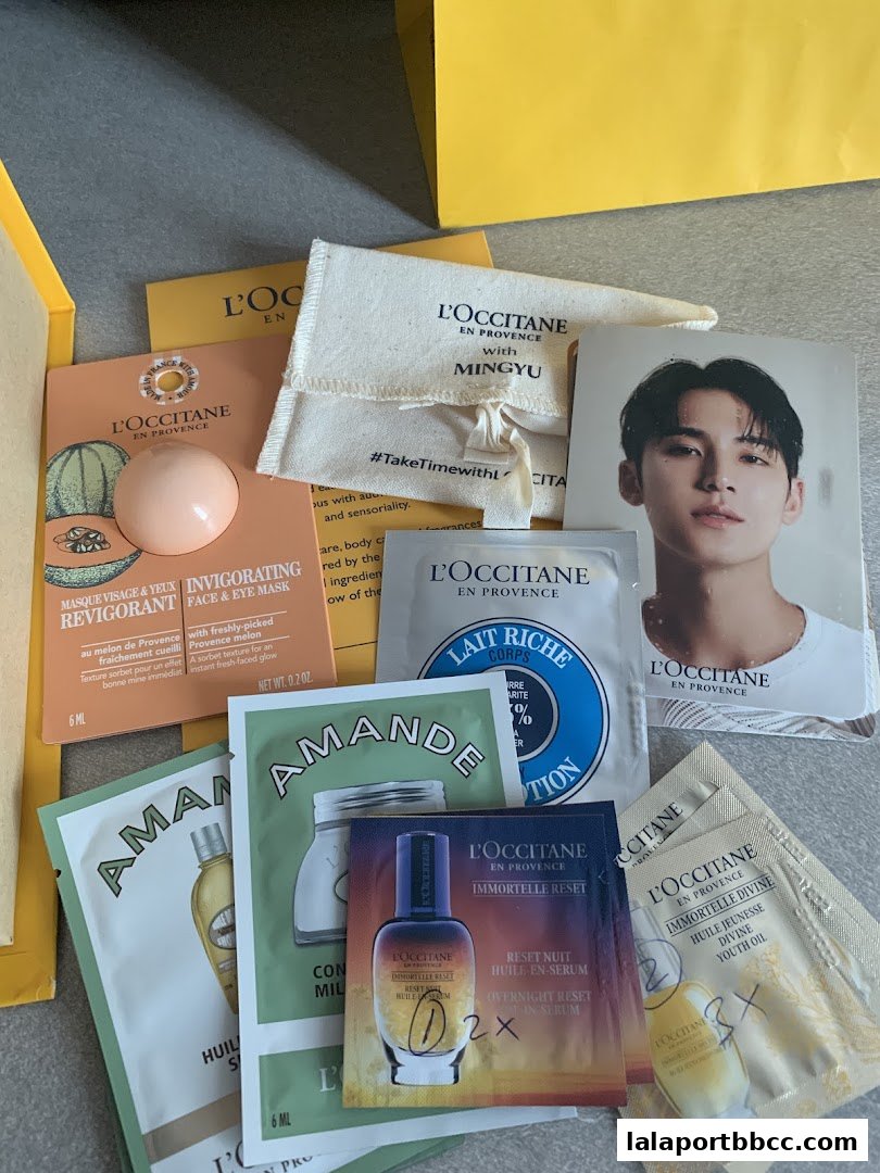 A collection of L'Occitane skincare samples and a promotional card featuring Mingyu.