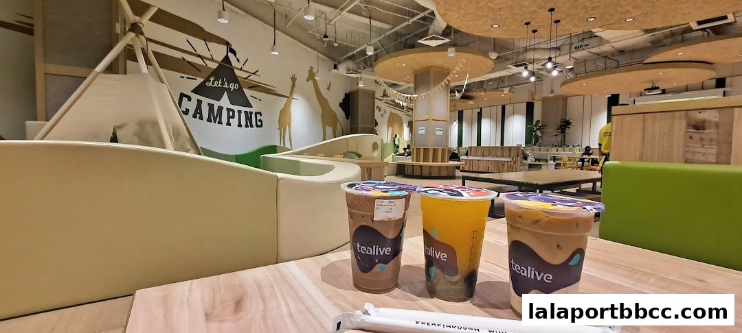 Three Tealive drinks on a wooden table with a playful camping-themed interior.