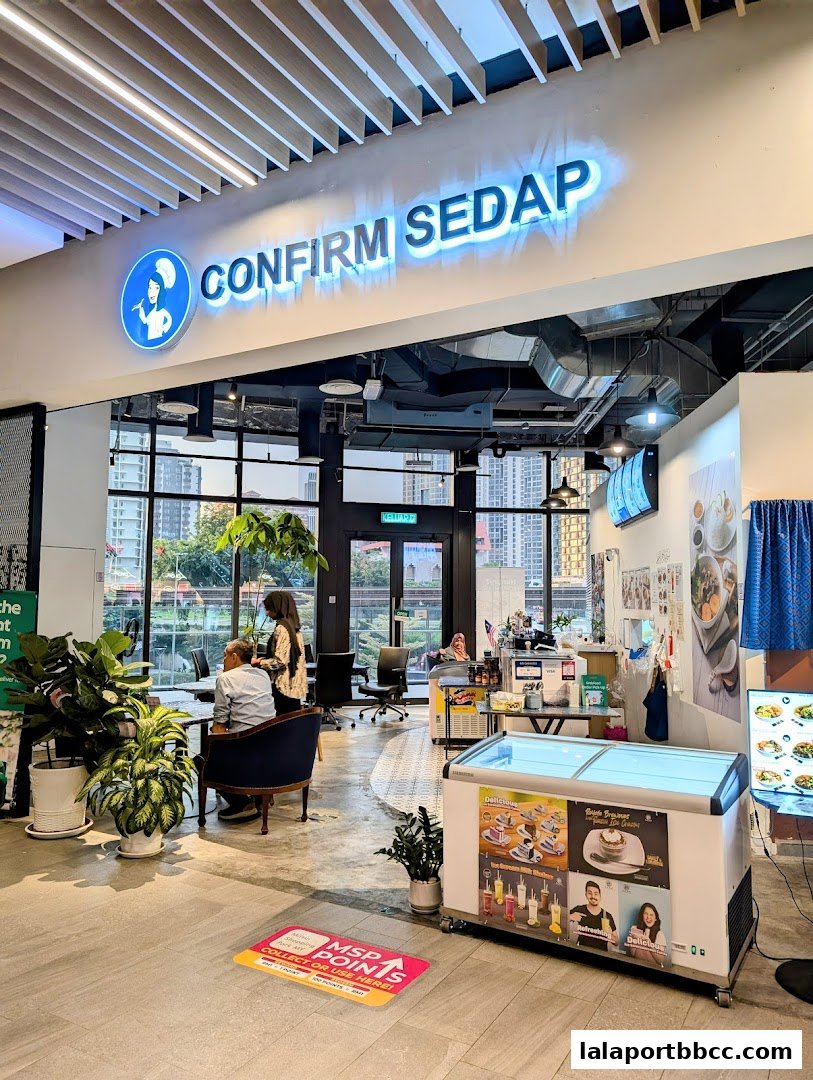 Interior view of Confirm Sedap restaurant with seating, counter, and display freezer.