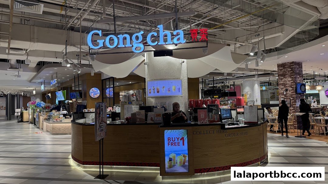 The Gong Cha bubble tea shop counter with staff and customers in a mall.