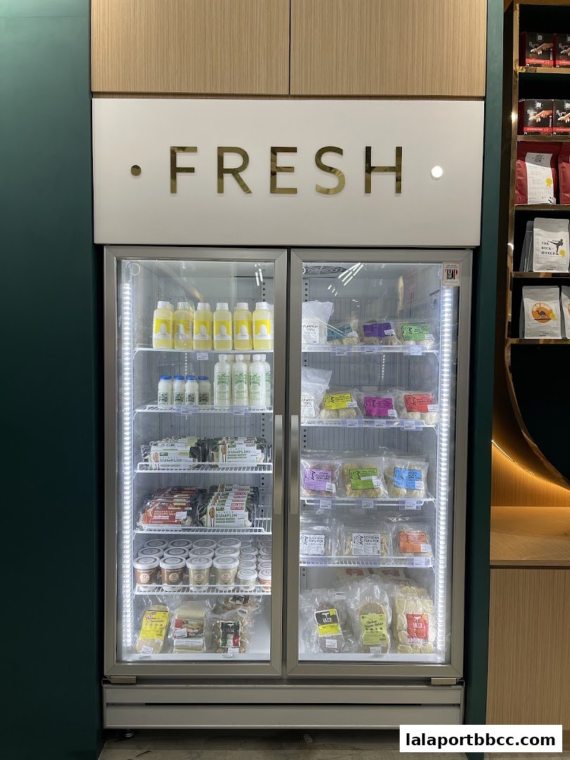 A refrigerated display case filled with various packaged food items and drinks.