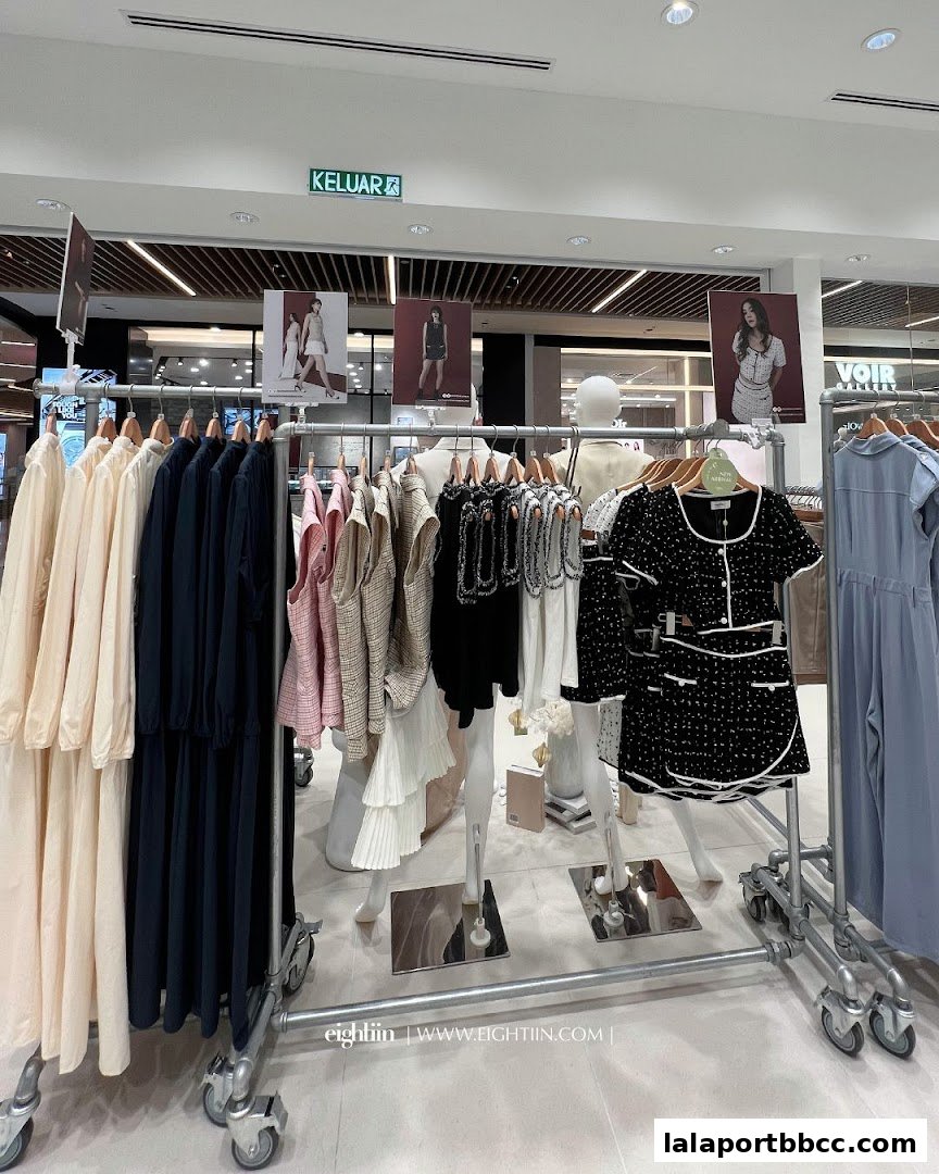 A display of fashionable women's clothing on racks inside a retail store.