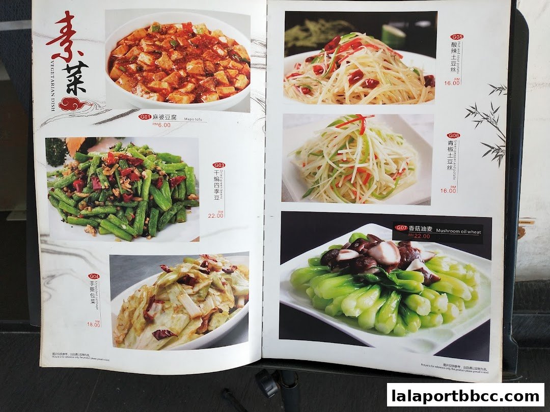 A menu page from a Chinese restaurant featuring various vegetarian dishes with images and prices.