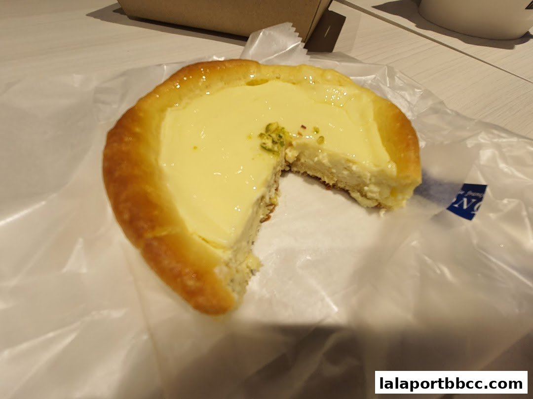 A delicious-looking pastry with a creamy filling and a golden crust, partially eaten.