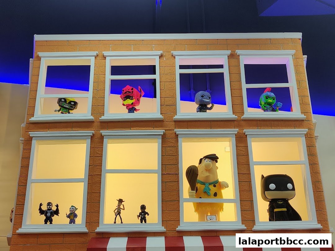 A display of popular Funko Pop figures in a brick building facade.