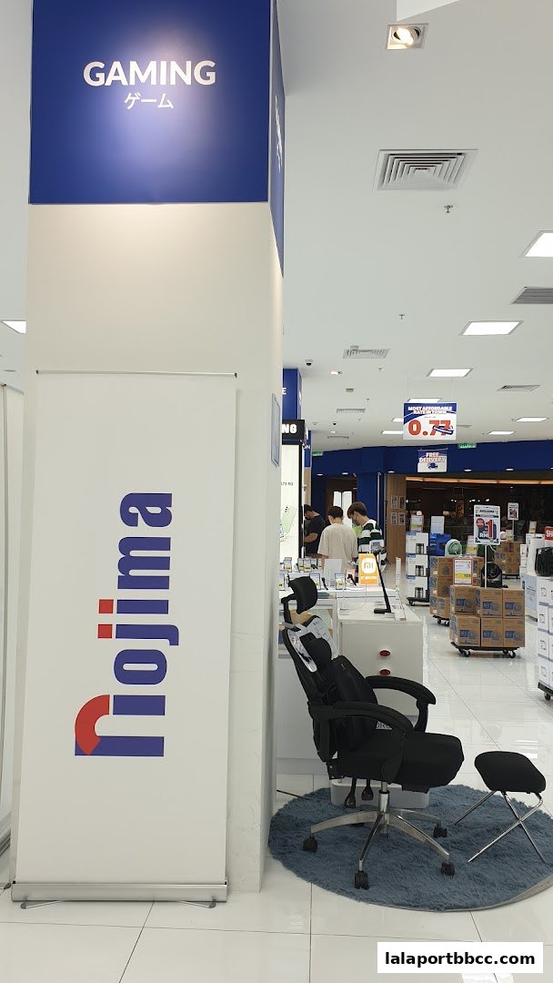 Interior view of a Nojima electronics store with a gaming section and various products on display.