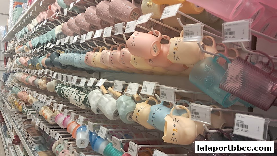 A wide selection of colorful mugs, many with cute animal designs, displayed on shelves.