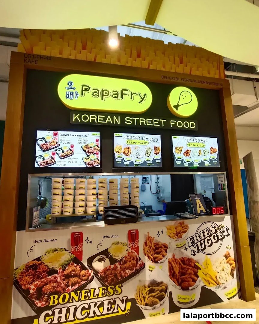 PapaFry Korean Street Food stall with digital menus and food displays.