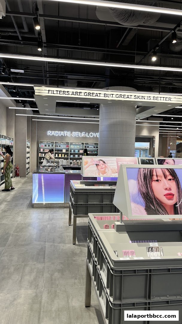 Interior view of a modern beauty store with displays of makeup and skincare products.