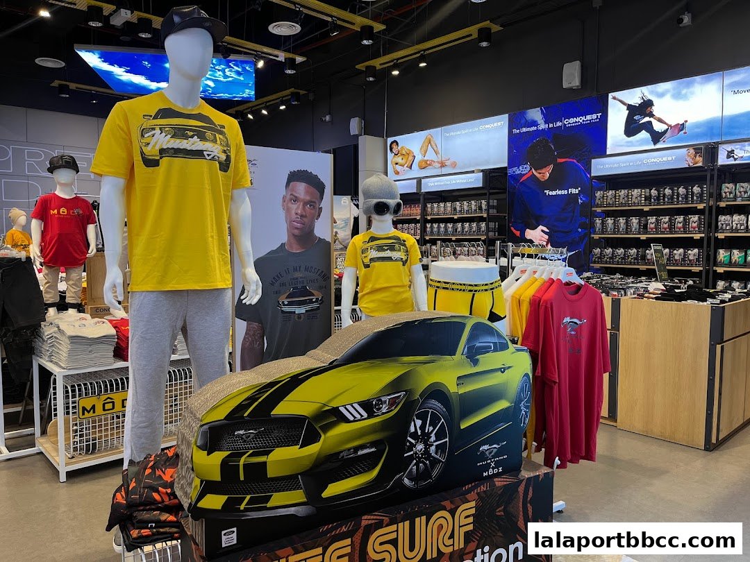 Mannequins and clothing displayed in a store with a Mustang car graphic.