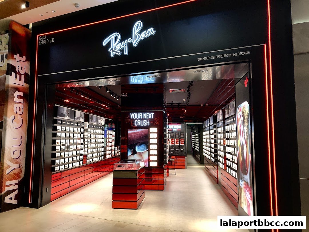 The modern Ray-Ban store features a sleek black facade with illuminated signage and displays of sunglasses.