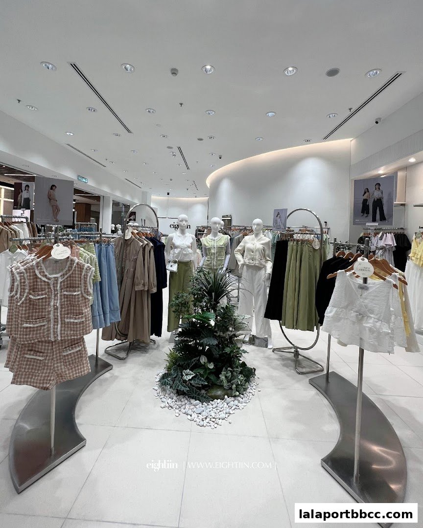Interior view of Eightiin Fashion store showcasing new arrivals on mannequins and racks.