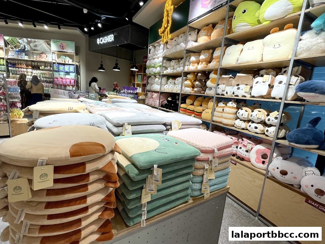 A retail store interior filled with plush toys, cushions, and various merchandise.