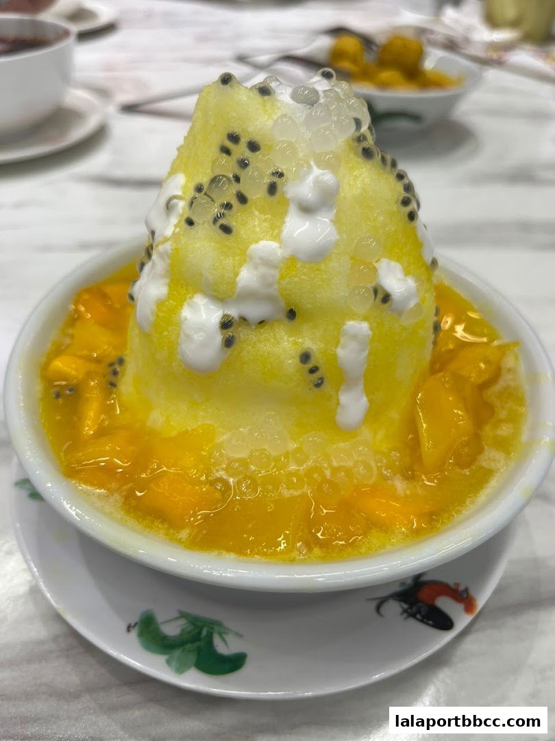A refreshing mango shaved ice dessert topped with passion fruit seeds and tapioca pearls.