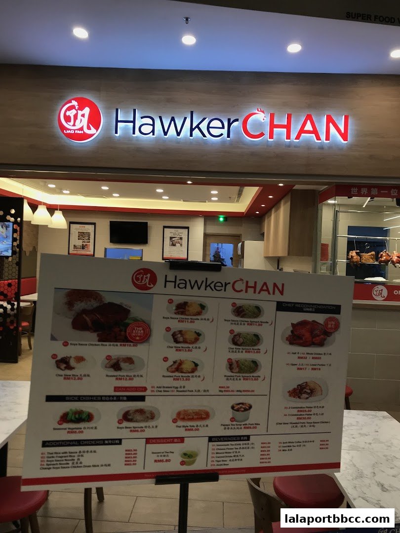 A menu board for Hawker Chan restaurant displaying various chicken rice and noodle dishes.