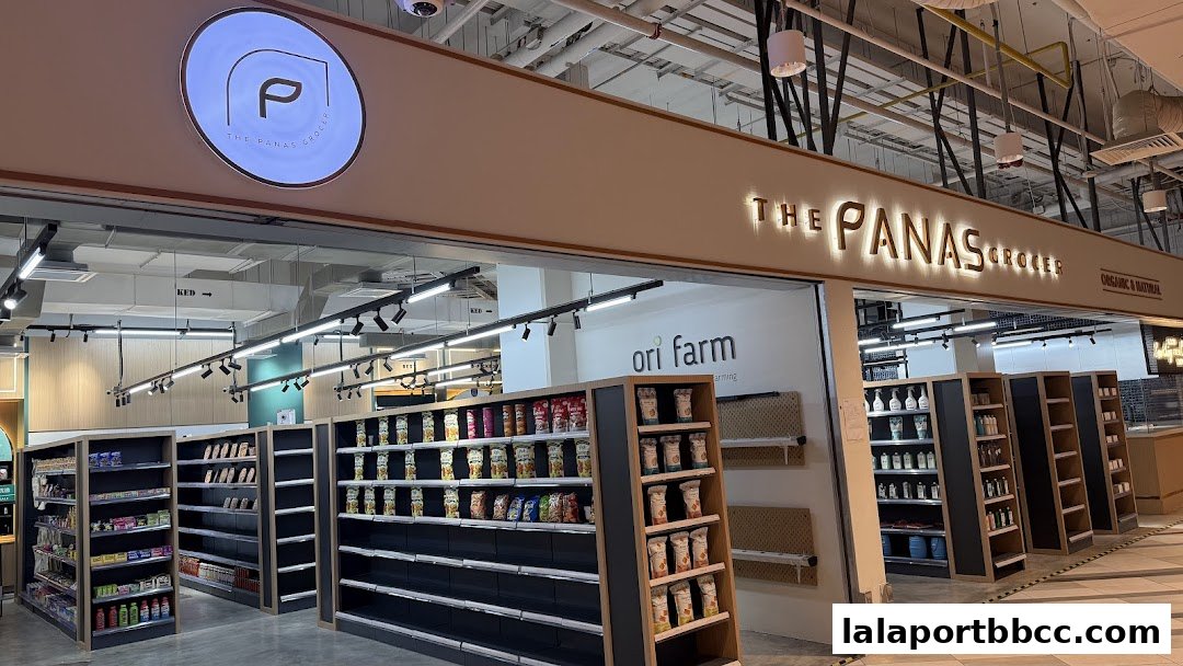 The Panas Grocer Lalaport Bukit Bintang shop entrance with shelves stocked with various products.