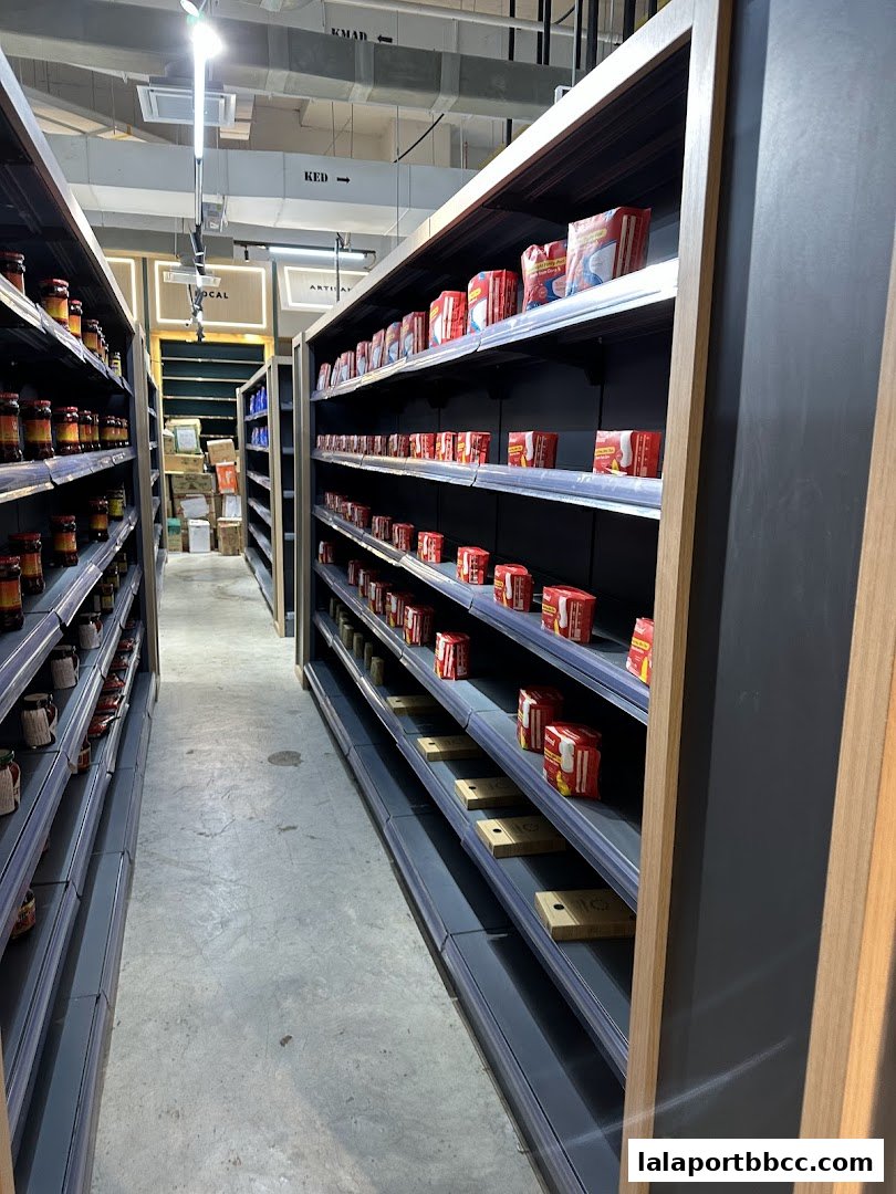 Aisle view of a grocery store with shelves stocked with various products.