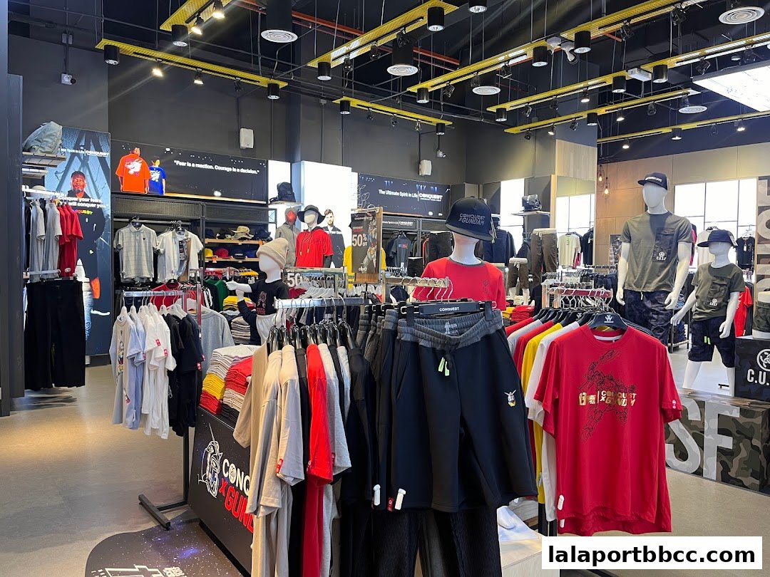 Interior view of a clothing store showcasing t-shirts, shorts, and mannequins.