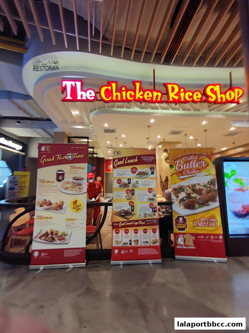 The Chicken Rice Shop storefront with promotional banners for lunch and tea time specials.