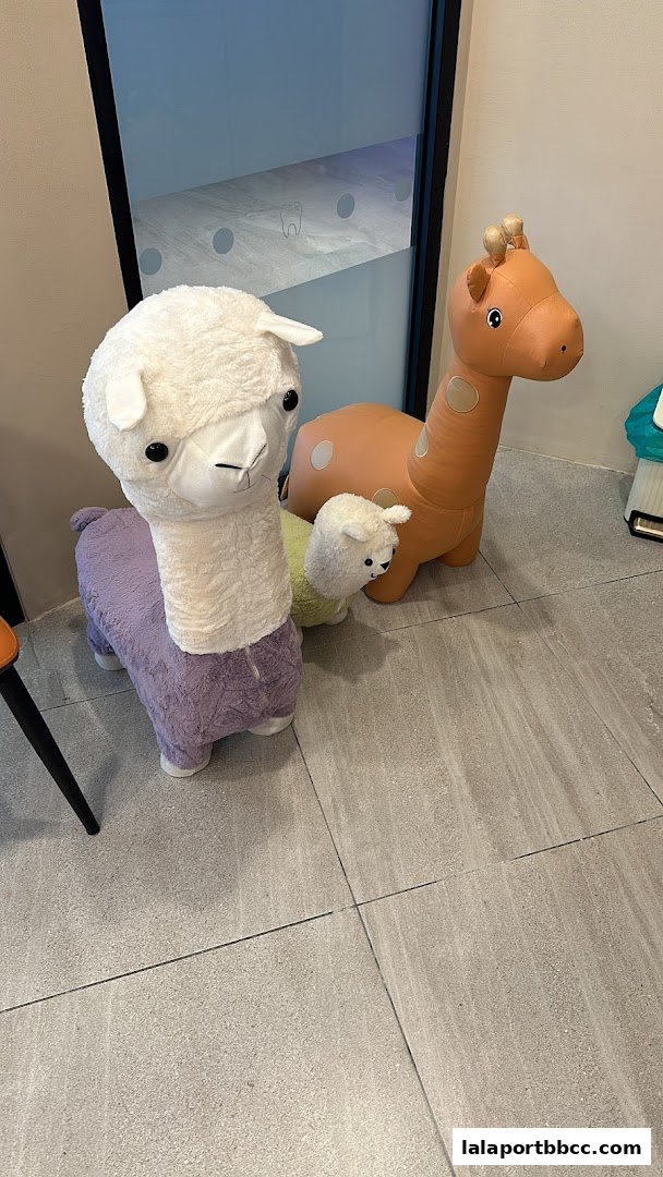 A dental clinic waiting area features playful animal-themed seating for children.