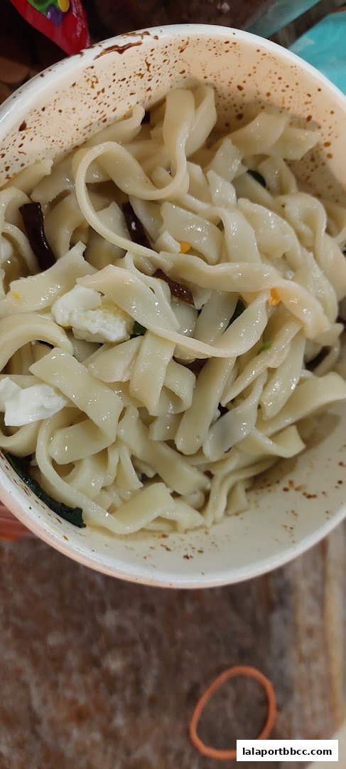 A close-up shot of a bowl filled with delicious-looking chili pan mee noodles.
