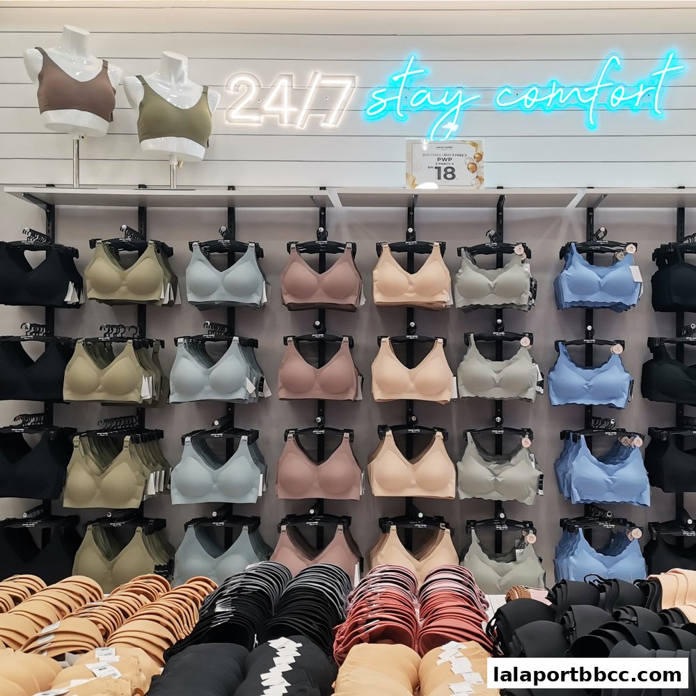 A wall display of various bras in different colors and styles, with mannequins at the top.
