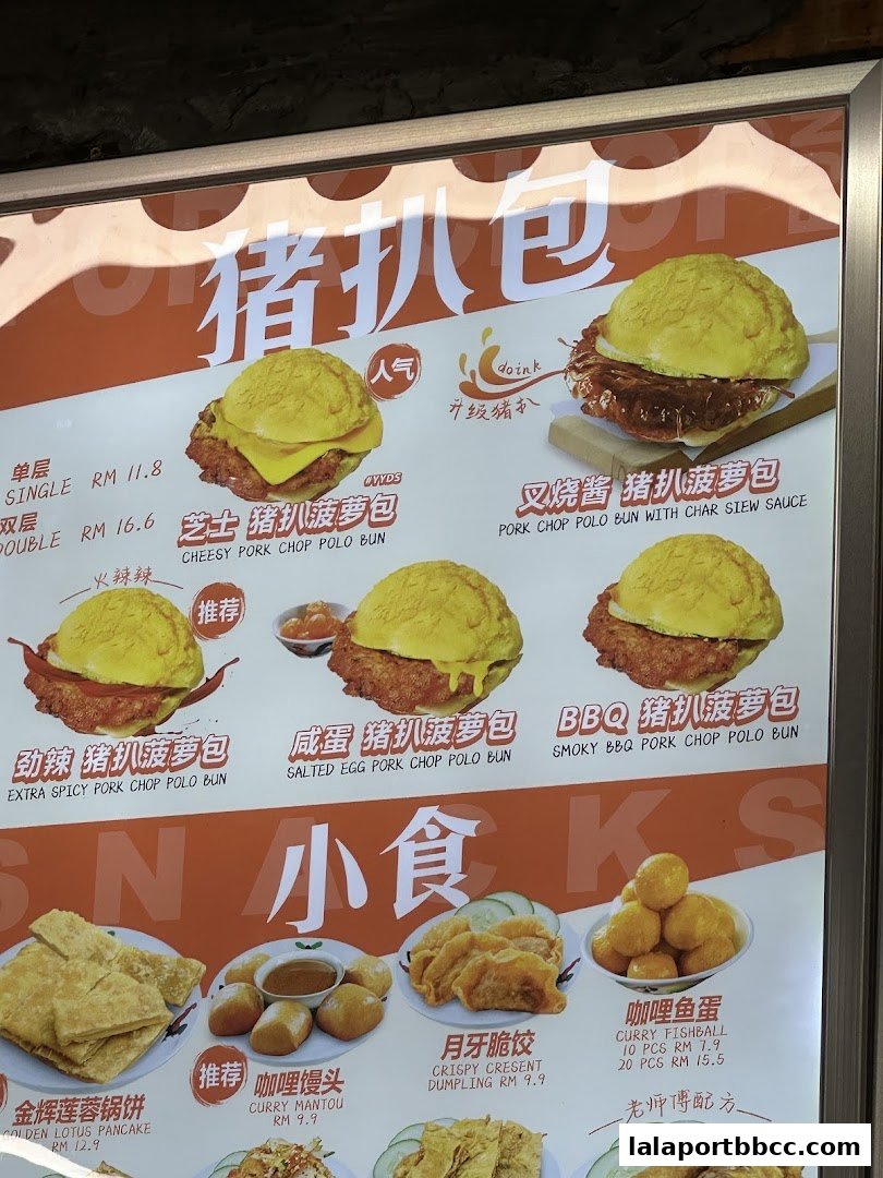 A menu board displaying various pork chop polo buns and snacks with prices.