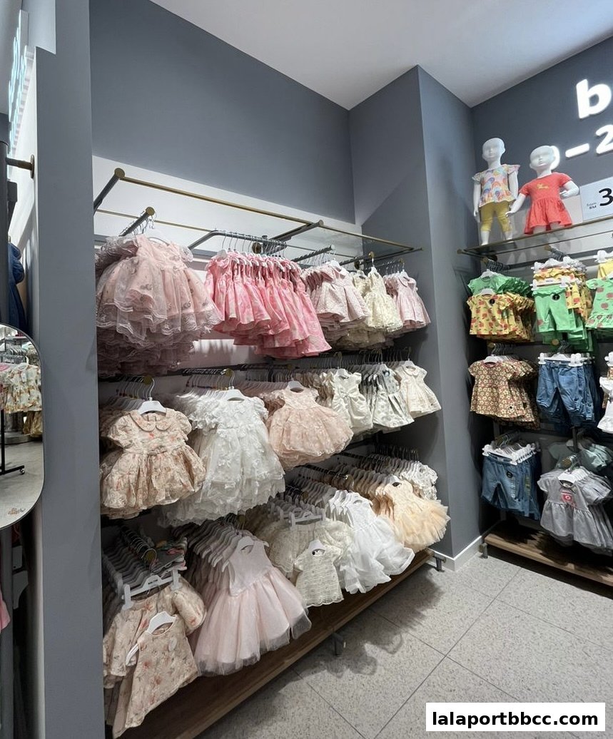 A well-organized display of baby dresses and outfits in various styles and colors.