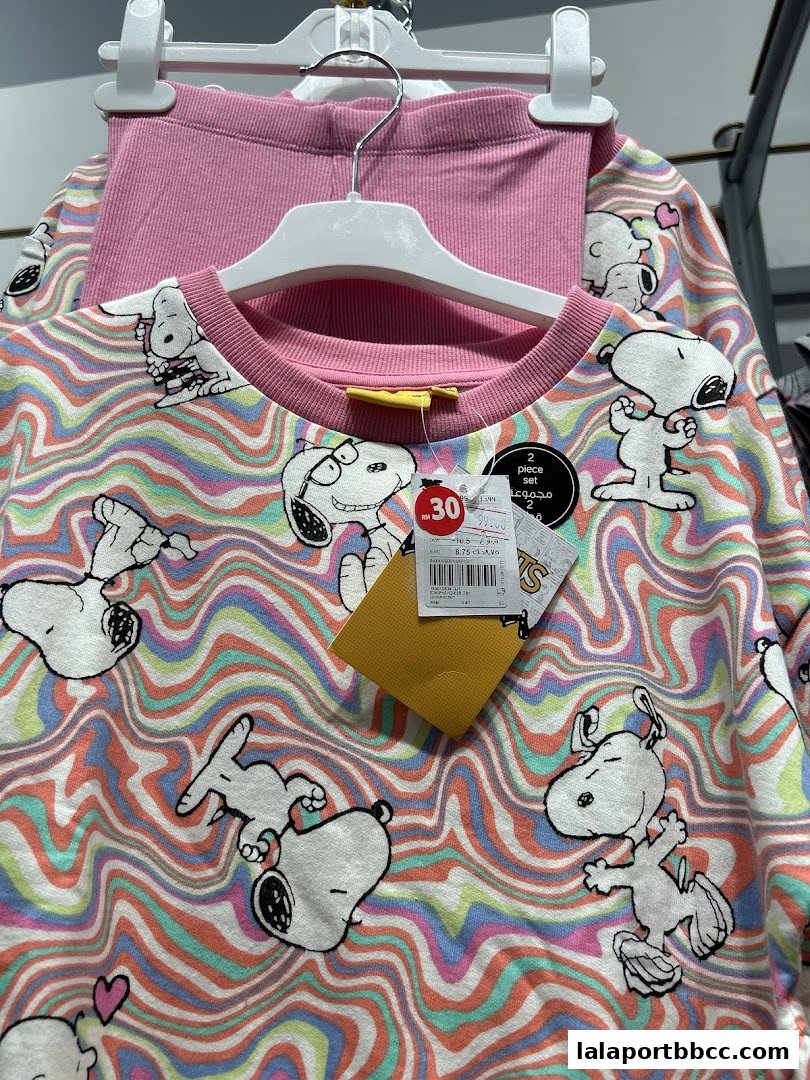 A Snoopy-themed two-piece children's outfit with a colorful wavy pattern.