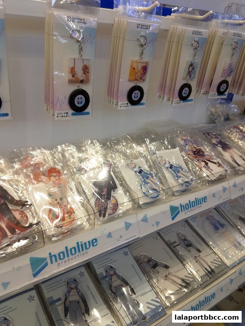 Animate shop display featuring Hololive production merchandise, including keychains and acrylic stands.