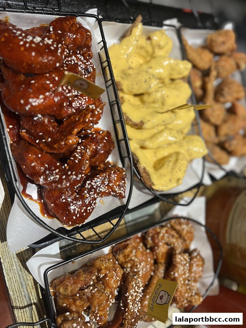 Baskets of crispy fried chicken wings with various sauces and seasonings.