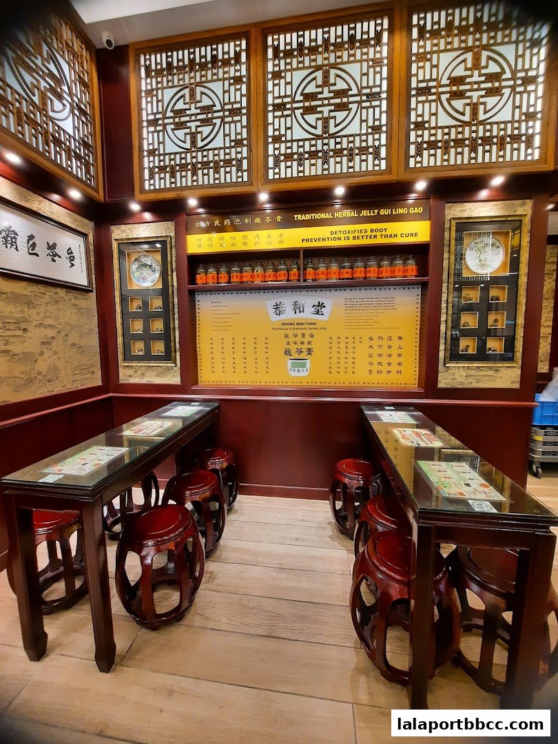Interior of Koong Woh Tong shop with traditional seating and herbal jelly display.